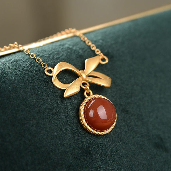 inlaid with southern red tourmaline round bow pendant ladies necklace